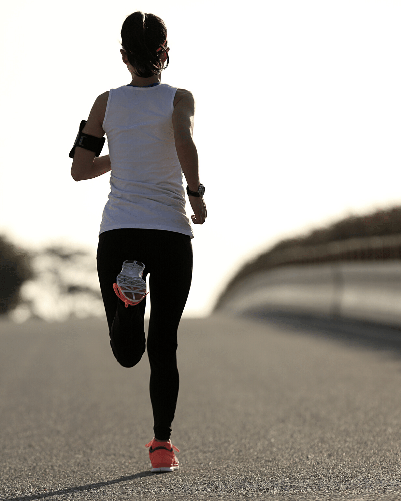 Should I train through pain? Female running on road