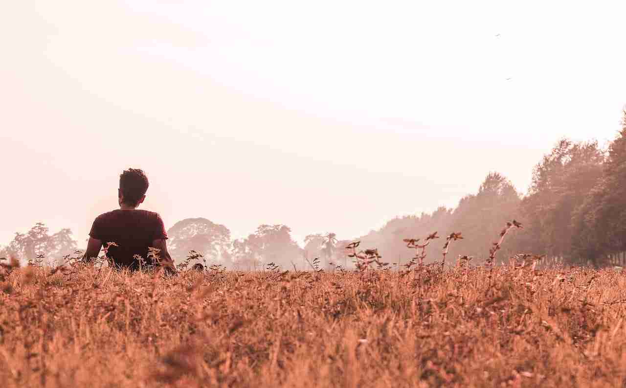 man sitting in field
