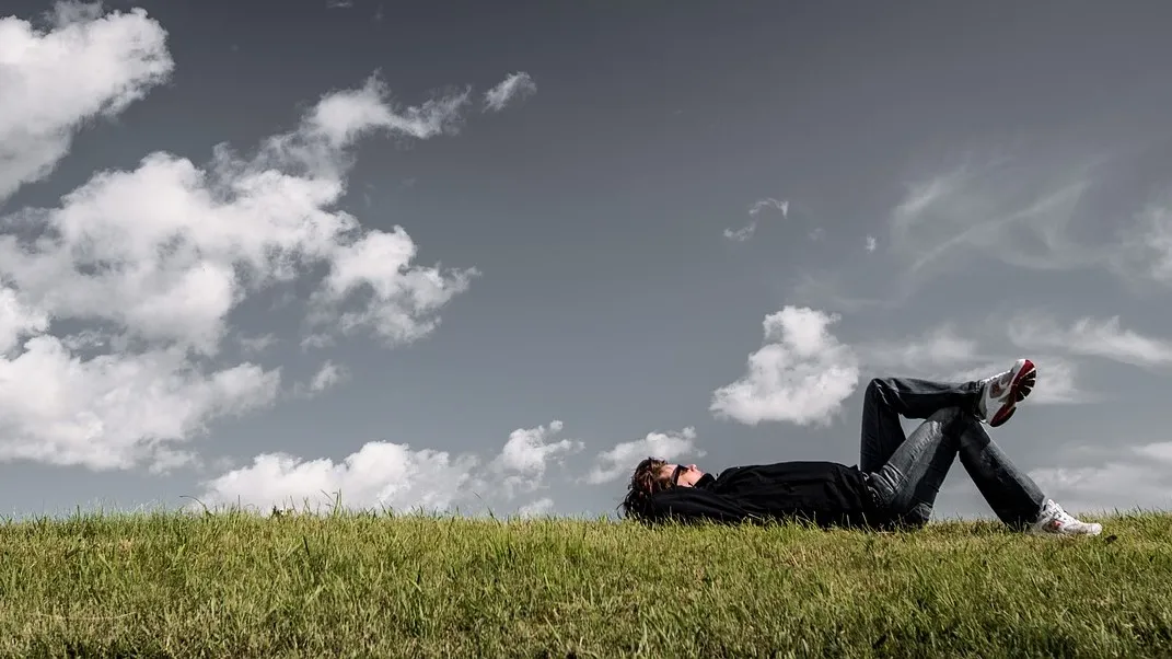 Why rest can be more harmful than the injury man lying in a grassy field